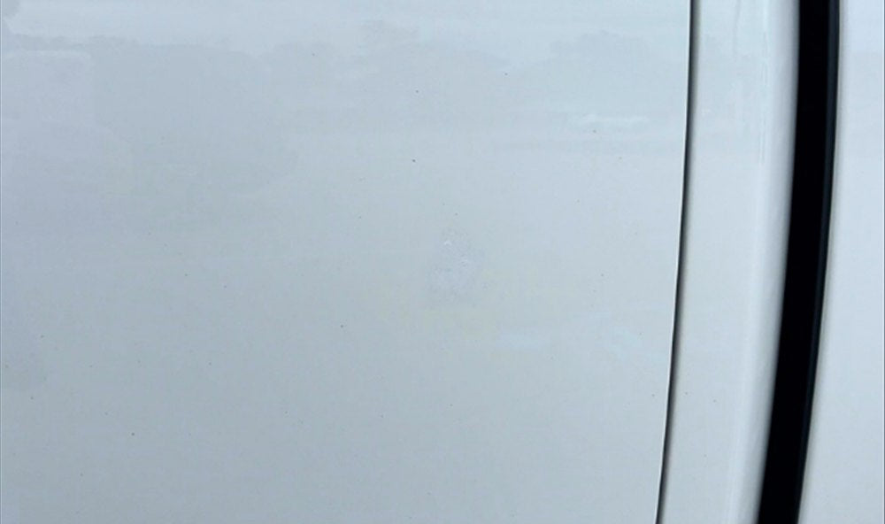 White vehicle panel after touch-up paint repair