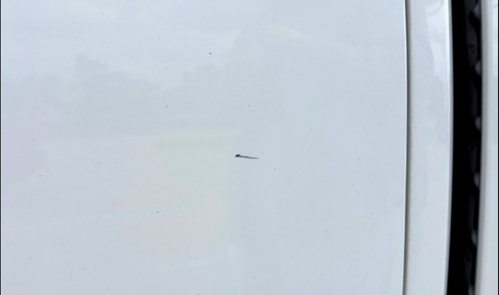 White vehicle panel before touch-up paint repair